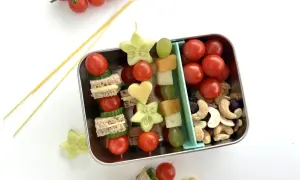 Bento-Box mit Spießen aus Mini-Sandwiches, Gurkensternen, Tomaten und Käseherzen. Ein tolles bento rezept für Kinder.
