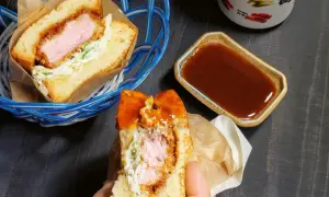 Ein saftiges Katsu Sando mit knuspriger Panade, Kohl und Sauce. Perfekt für einen schnellen, leckeren Snack.