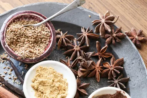 Gewürze wie Sternanis, Zimt und Vanille, bereit als Sternanis-Ersatz für ein festliches Backrezept.