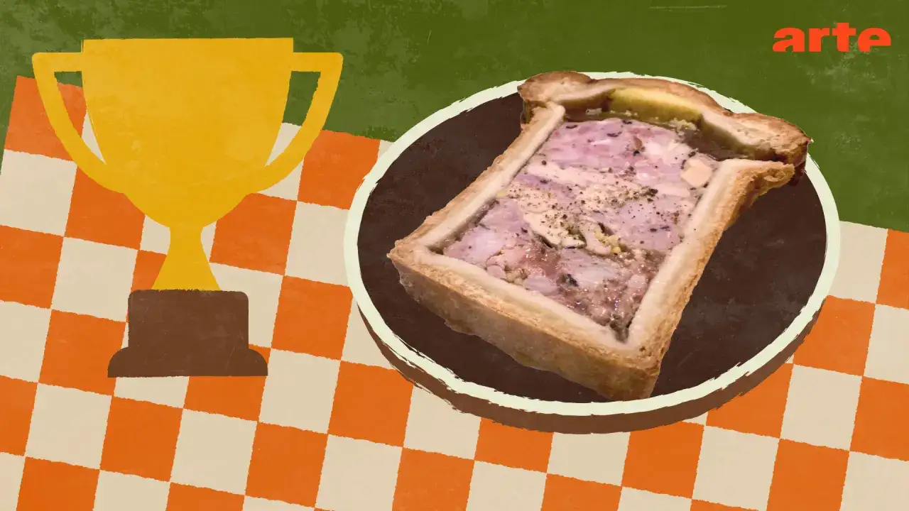 Goldener Pokal neben einem k&ouml;stlichen Pate en croute auf kariertem Tisch.