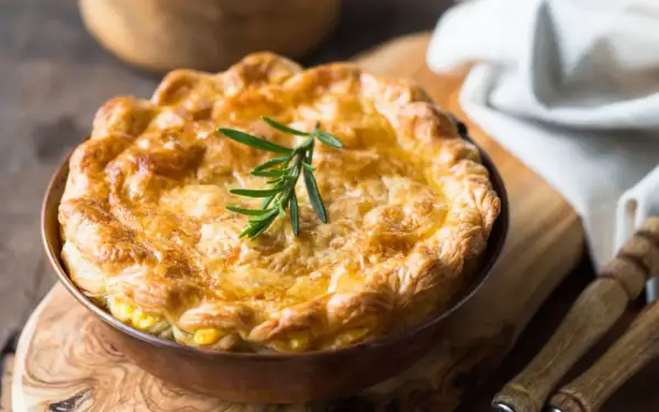 Goldbrauner, knuspriger Pot Pie mit Rosmarinzweig, bereit zum Servieren.